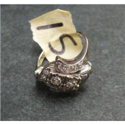 Lady's ring with 2 approx 0.25 carats diamond, all set in white gold, with approx. 9 small diamonds 