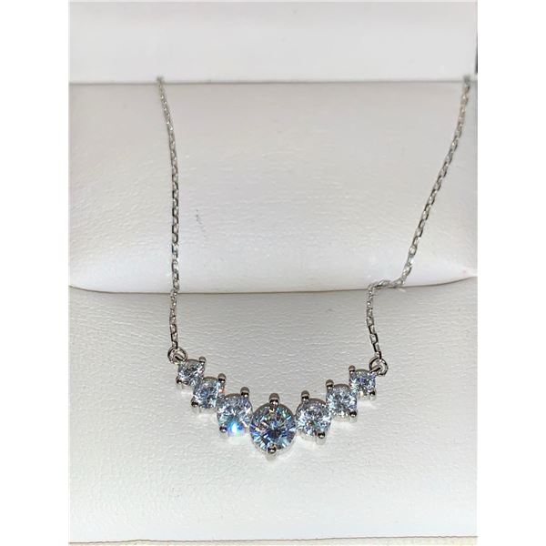 GRA CERTIFIED MOISSANITE WEIGHING AN ESTIMATED 0.50 CARATS IN THE CENTER WITH 3 GRADUATING MOISSANIT