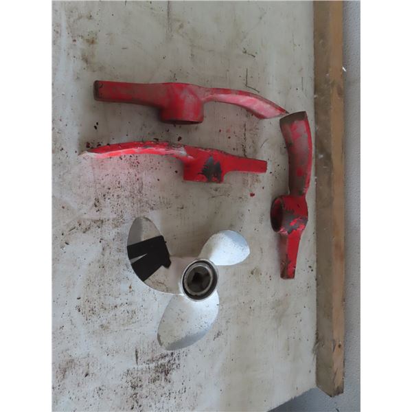 3 axe heads and boat propellor