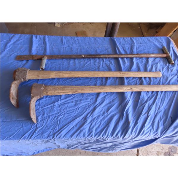 two grub hoes and rooting tool