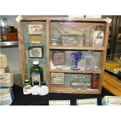 Old Shadow Box display of various medicinal bottles and boxes: including- blue glass eye wash cup (8