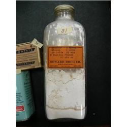 Old bottle with screw on lid and with old original Seward Drug Company dusting powder made from camp
