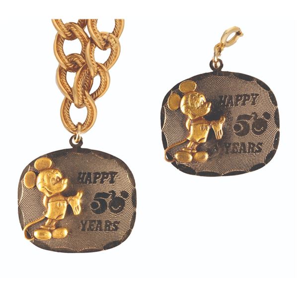 A Walt Disney Productions 50th Pendant and Bracelet.