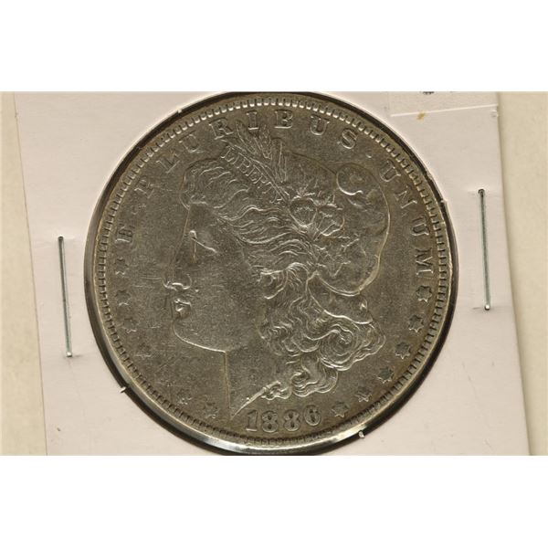 1886 MORGAN SILVER DOLLAR. DISCOLORED ON REVERSE