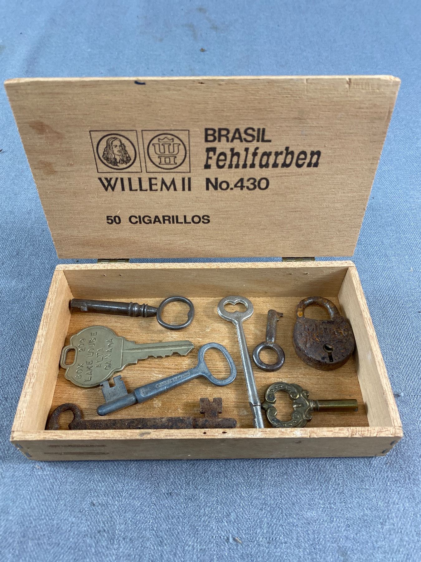 Collection of Vintage Keys in Wood Cigar Box