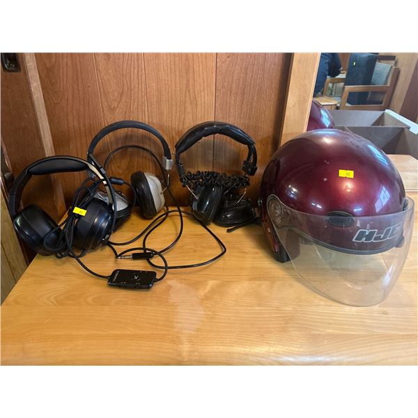 Three Headsets And Motorcycle Helmet