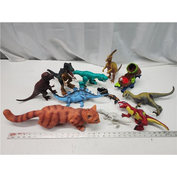 Bundle of toy dinosaurs and large cat