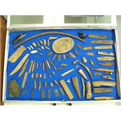 Collection of bone, ivory and slate artifacts from St. Lawrence Island- including a caribou hoof bel