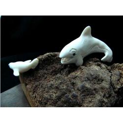 White ivory killer whale chasing seal mounted on whale bone on wood base- 6" length, 4" height (3)