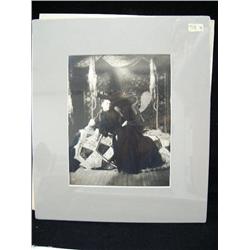 CHOICE on 8 original photographs of Alaska: (g) white woman reclining on fancy seal blanket Nome, Al