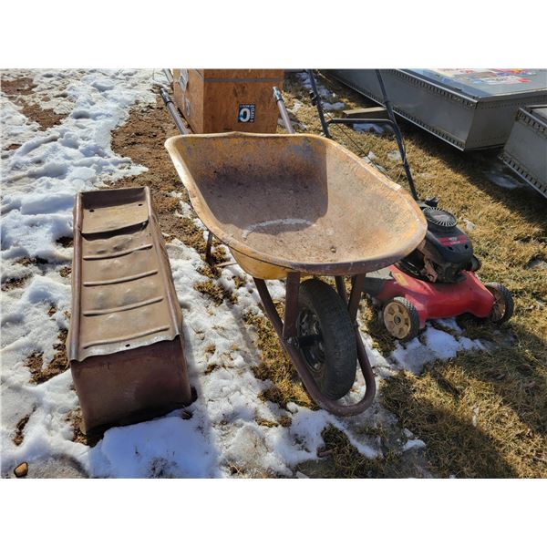 Wheel barrow; lawn mower (condition unknown); pair of metal ramps