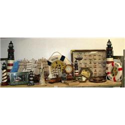 Shelf of nautical items: 5 model ships, 2 large lighthouses, 5 smaller lighthouses, 2 "WELCOME ABOAR