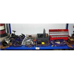 Shelf full of: misc. fishing reels, 115-piece drill bit set, Dremmel Roto-tool (104)