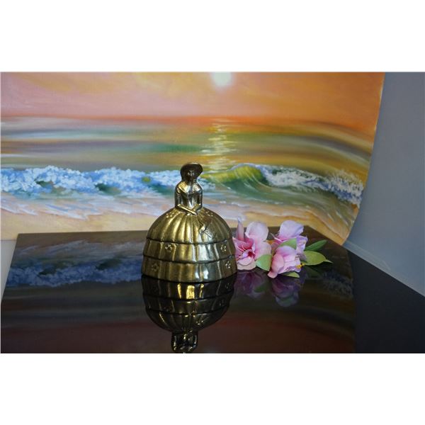 Vintage brass bell lady in a large dress shape