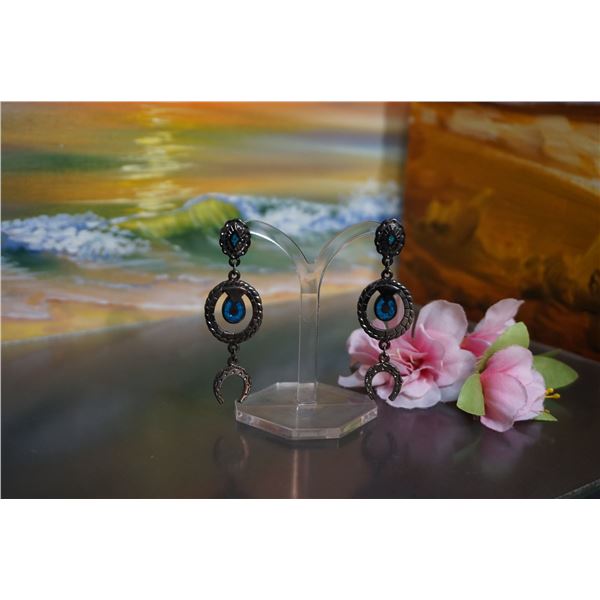 Large silver tone stud earrings with turquoise horse shoe