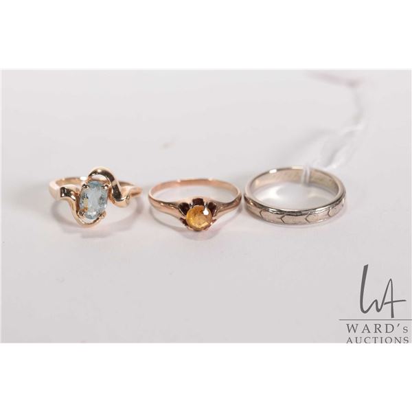 Three gold rings including 10kt set with yellow gemstone size 6.5, 14kt yellow gold set with aquamar