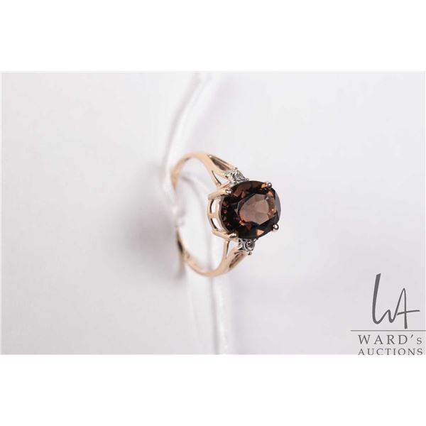 Ladies 10kt yellow gold, smoky quartz ring set with two small accent diamonds, size 6.5