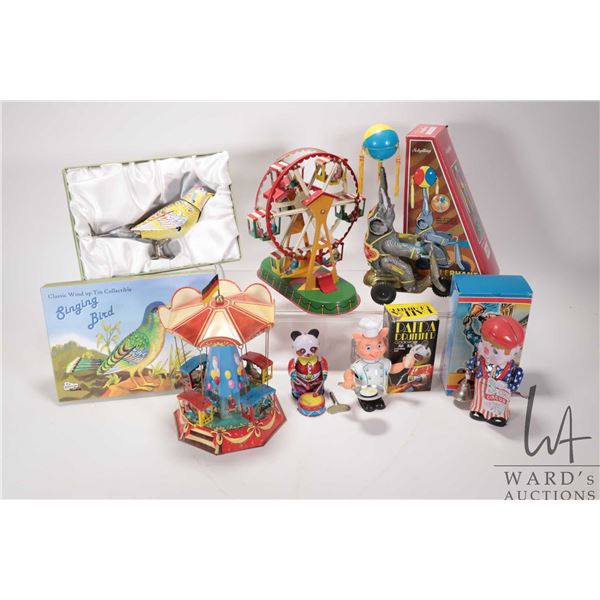 Selection of modern key wind collectible mechanical toys including Merry-go-round, Ferris wheel, ele