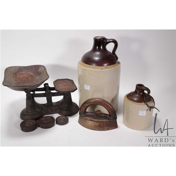 Selection of primitive collectibles including two stoneware jugs, sadiron with handle and a balance 