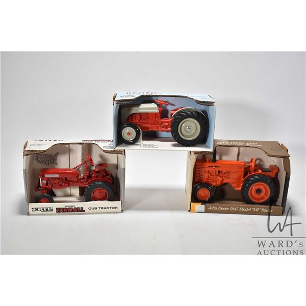 Three Ertl 1:16 scale die cast toys including Ford 8N, John Deere 1947 model MI and Farmall Cub trac