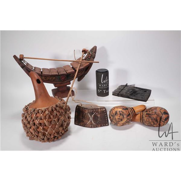 Selection of treenware musical instruments including shakers, maracas, xylophone, finger organ etc.