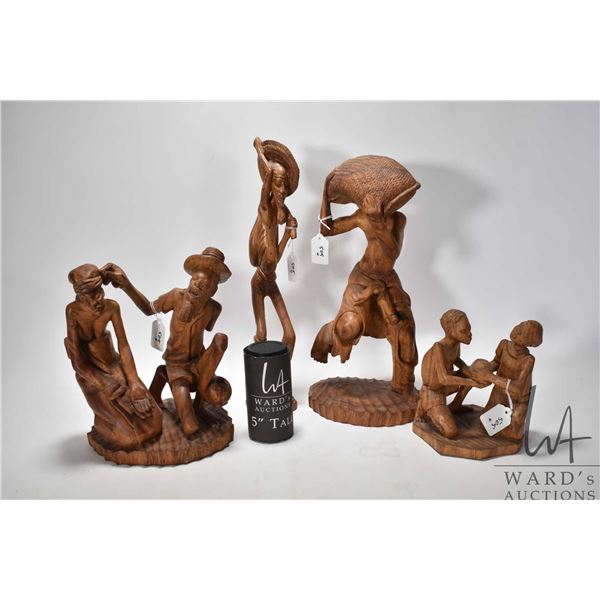 Four carved wooden figures including 16" man w/ sack, 11" man & woman, 8" two children and 17" tall 