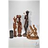 Image 1 : Four carved wooden figures including 20" man w/ club, 16" woman w/ basket, 15" woman w/ child and 10