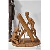 Image 2 : Four carved wooden figures including 20" man w/ club, 16" woman w/ basket, 15" woman w/ child and 10