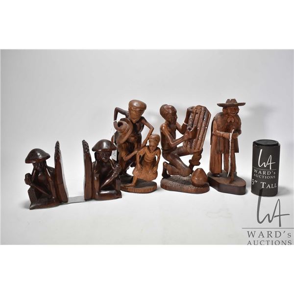 Four carved wooden figures including 6" bookends, 10" woman w/ cane, 10" parents w/ child and 9" man