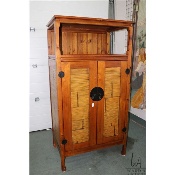 Semi contemporary entertainment unit with two doors inset with bamboo, hand hammered hardware, fitte