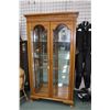 Image 1 : Modern oak illuminated two door display cabinet with dental molding on crown, beveled panels and gla