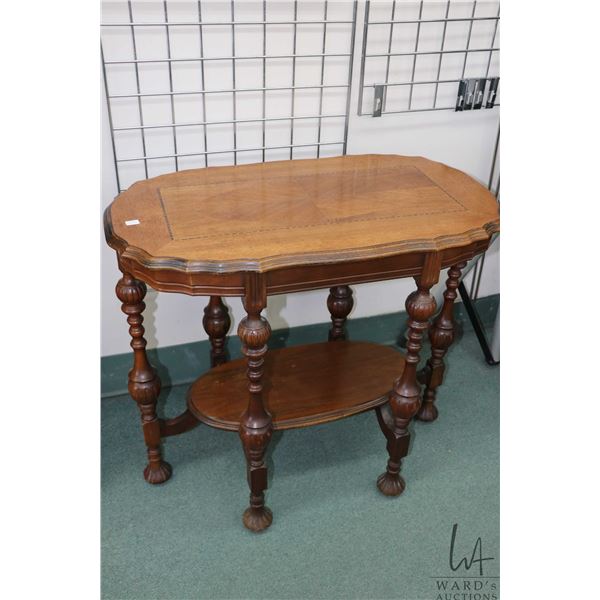 Mid 20th century, six legged occasional table with matched grain and inlaid top, under shelf and bul