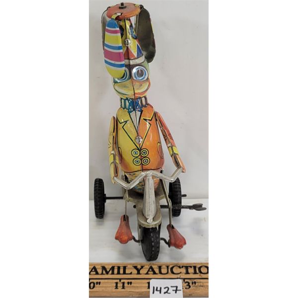 WIND-UP TOY DUCK RIDING A TRI-CYCLE 