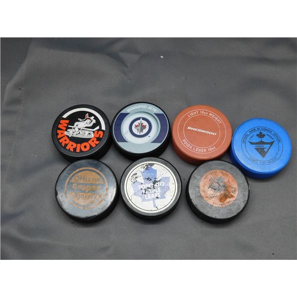 Lot of 7 Assorted NHL Hockey Pucks Jets, Warriors, Etc