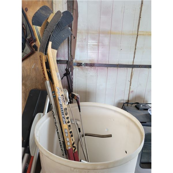 5- Hockey sticks, 4- golf clubs & white barrel