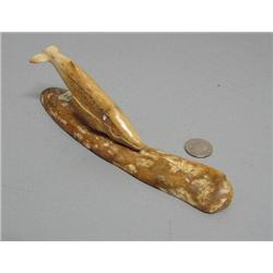 Whale carved from fossilized bone mounted on fossilized bone- base is 8-1/4" and whale is 5"