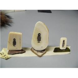Lot of 3 scrimshawed ivory platchets with girl in parka- one mounted on fossilized ivory bark, one o