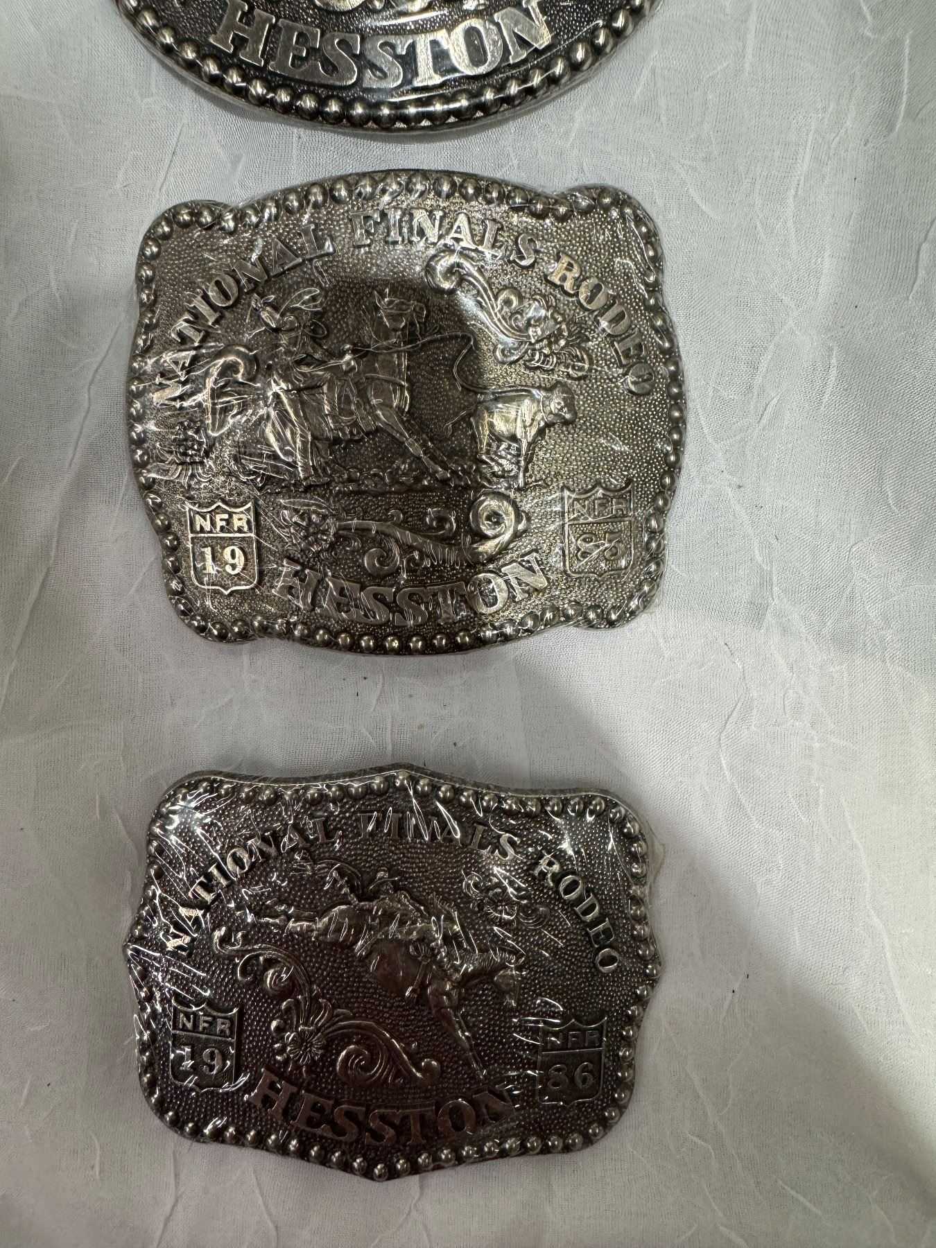 National Finals rodeo belt buckles 1-8edditiin and 1991