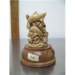 5" bone carving on wood base of four swimming whales- imported, not Alaskan ()