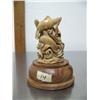 Image 1 : 5" bone carving on wood base of four swimming whales- imported, not Alaskan ()
