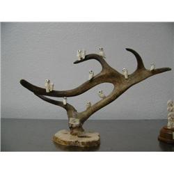 12 ivory birds with inset fossilized ivory eyes and baleen noses mounted on caribou horn with bone b