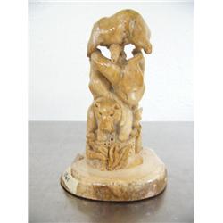 Bone carving 5-1/2" tall of an otter family with 2 salmon ()