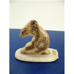 Carved fossilized ivory bear mounted on ivory base by Vincent Ahkinga from Little Diomede ()