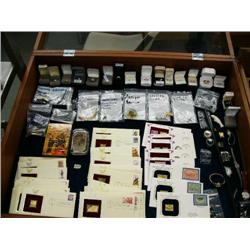 Display case full of Gold Collector's Stamps, sterling and gold rings with diamonds, various other p