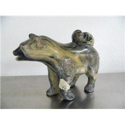 7-1/2" soapstone carved husky with tail laying up on its back by Eddie Lee ()