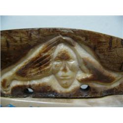 6" relief carved fossilized ivory sled runner with whale, man's face, scrimshawed ivory man with dog