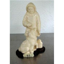 Mammoth ivory carving of Alaskan Native with sled dog on wood base- 5" high- Russian ()