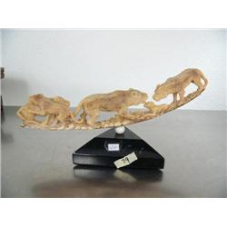 Fossilized ivory group of saber tooth tigers feasting on a dall sheep mounted on triangular shaped s