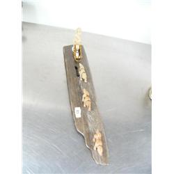 Dog sled scene made of bone- 15" long and 3" high with bone man and 3 bone sled dogs with ivory seal