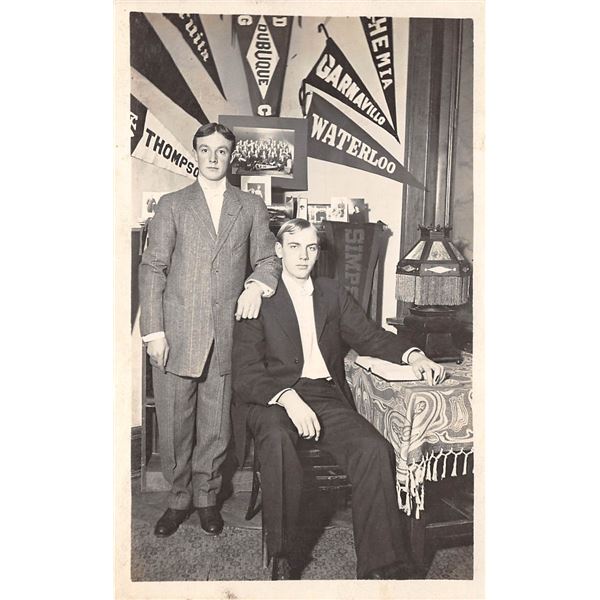Two Men In Front Of College Photos & Pennants Real Photo Postcard